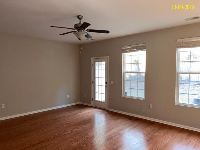 unfurnished room with ceiling fan and dark hardwood / wood-style flooring