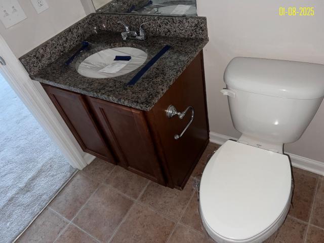 bathroom featuring vanity and toilet