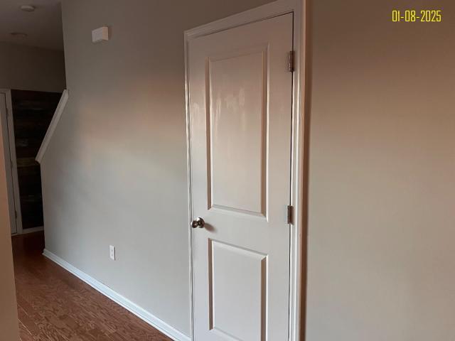 hall with dark hardwood / wood-style flooring