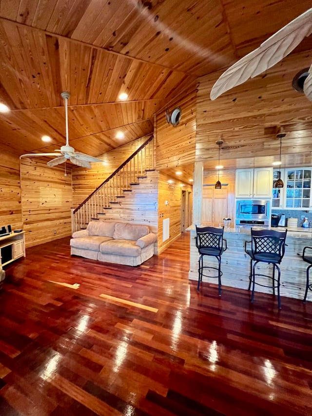 living room featuring wood walls, hardwood / wood-style floors, and wood ceiling