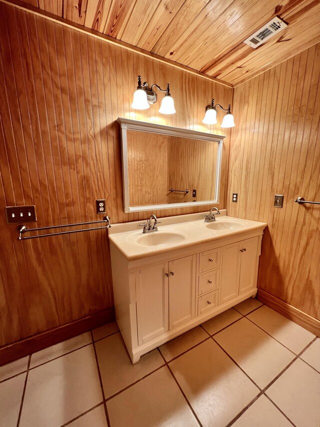 bathroom with tile flooring, dual vanity, wood ceiling, and wood walls