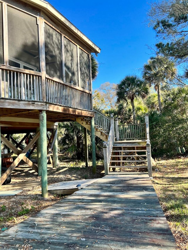 exterior space with a sunroom and a wooden deck