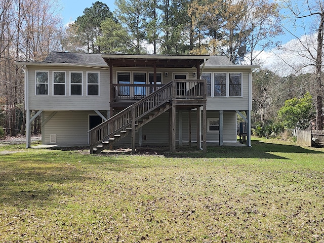 back of property with a deck, stairway, and a lawn