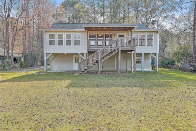 coastal inspired home with stairway, a front yard, and a wooden deck