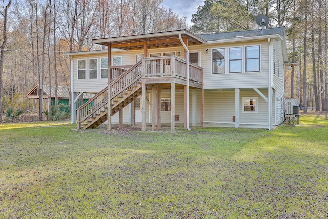 raised beach house featuring a deck, a front lawn, and stairway