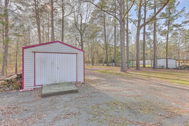 view of outbuilding with an outdoor structure and driveway