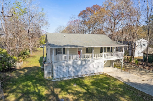 view of front facade with a shingled roof, covered porch, a garage, driveway, and a front lawn