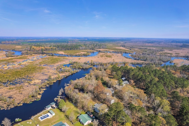 aerial view with a water view and a forest view