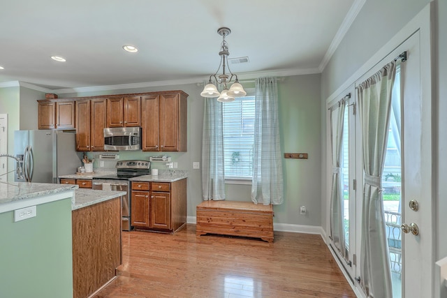 1408 Bimini Dr, Charleston, SC 29414 - kitchen with stainless steel appliances, brown cabinets, crown molding, decorative light fixtures, and light wood finished floors