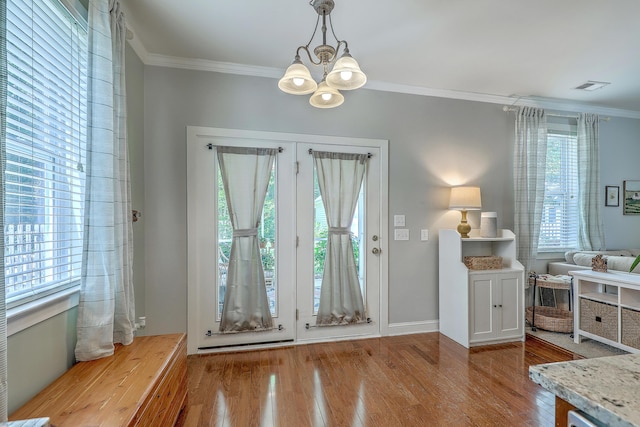 1408 Bimini Dr, Charleston, SC 29414 - entryway featuring a chandelier, wood finished floors, crown molding, and baseboards