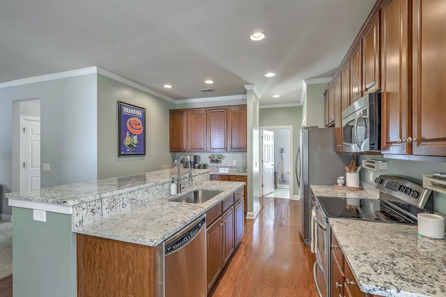 1408 Bimini Dr, Charleston, SC 29414 - kitchen with appliances with stainless steel finishes, a sink, ornamental molding, a center island with sink, and light wood finished floors