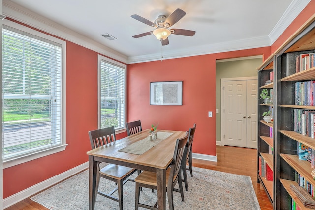 1408 Bimini Dr, Charleston, SC 29414 - dining room featuring wood finished floors, a ceiling fan, crown molding, and baseboards
