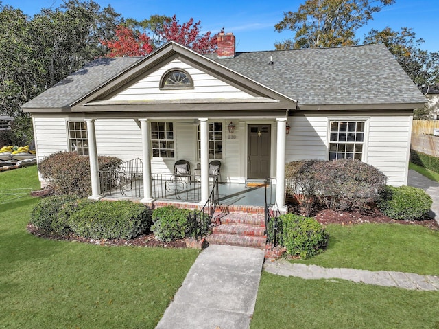 view of front of house featuring a porch and a front lawn