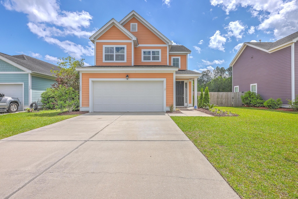 120 Indigo Marsh Cir, Wando, SC 29492 - view of front of home featuring a front yard, fence, a garage, and concrete driveway