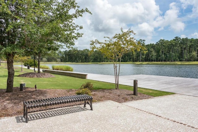 exterior space featuring a lawn and a water view