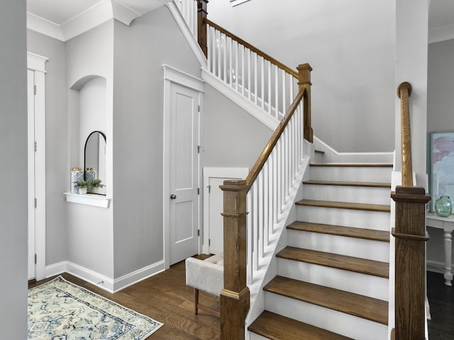 stairway featuring hardwood / wood-style flooring and crown molding