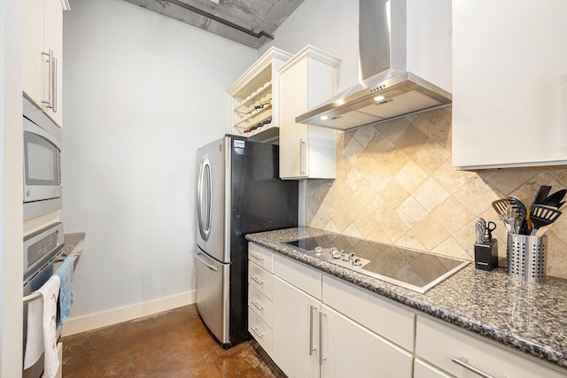 kitchen featuring stainless steel appliances, white cabinetry, baseboards, backsplash, and wall chimney exhaust hood