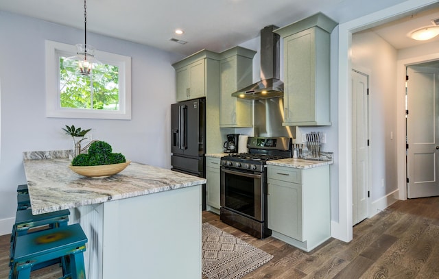 206 Ashley Ave Unit A, B, C, D, E, Charleston, SC 29403 - kitchen featuring visible vents, freestanding refrigerator, a breakfast bar area, wall chimney range hood, and stainless steel range with gas cooktop