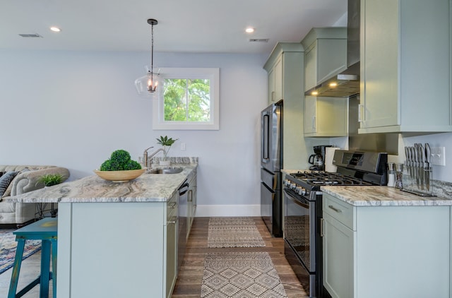 kitchen featuring light stone countertops, a breakfast bar area, stainless steel appliances, sink, and wall chimney range hood