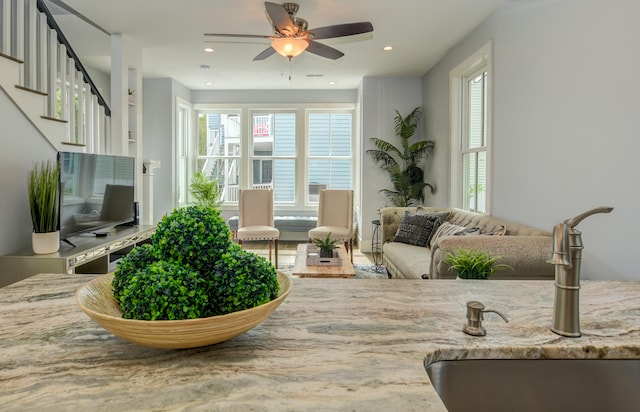 living room with ceiling fan and sink