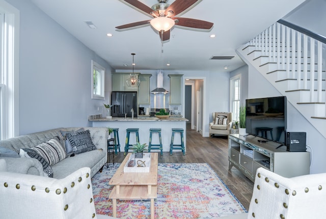 living room featuring ceiling fan, sink, dark wood-type flooring, and a wealth of natural light