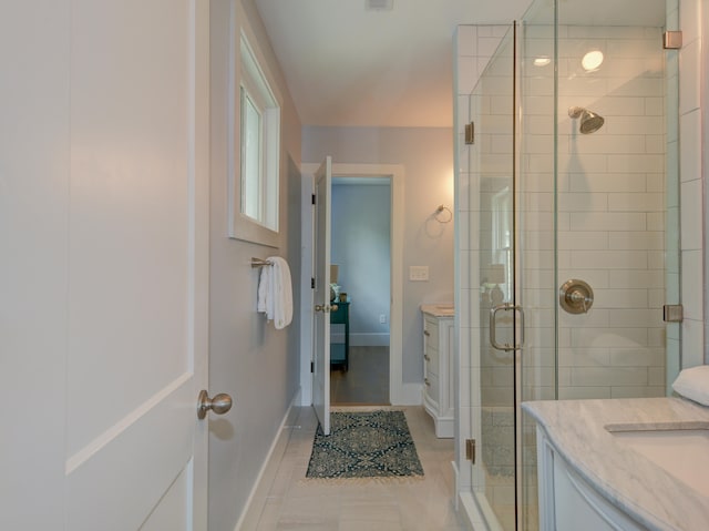 bathroom featuring vanity, a shower with door, and tile patterned floors