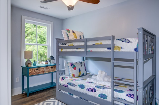 bedroom with dark hardwood / wood-style flooring and ceiling fan