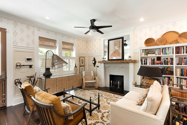 1012 Ashley Ave, Charleston, SC 29403 - living room featuring wallpapered walls, a ceiling fan, a decorative wall, dark wood-type flooring, and ornamental molding