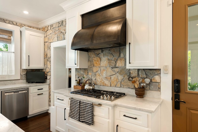 1012 Ashley Ave, Charleston, SC 29403 - kitchen with stainless steel appliances, backsplash, premium range hood, crown molding, and white cabinetry