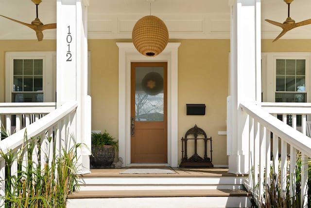 1012 Ashley Ave, Charleston, SC 29403 - doorway to property with a ceiling fan, covered porch, and stucco siding