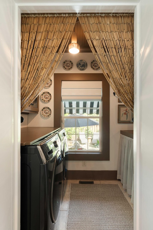 1012 Ashley Ave, Charleston, SC 29403 - laundry area with visible vents, tile patterned floors, washing machine and clothes dryer, and laundry area