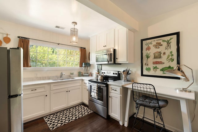 1012 Ashley Ave, Charleston, SC 29403 - kitchen featuring white cabinets, light countertops, visible vents, a sink, and appliances with stainless steel finishes