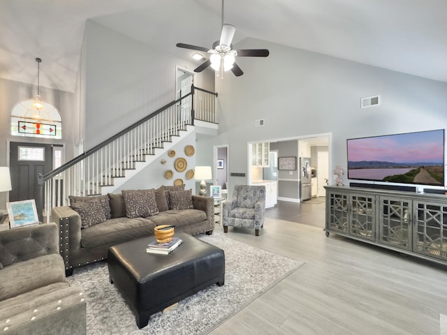482 Planters Trace Dr, Charleston, SC 29412 - living area featuring high vaulted ceiling, stairs, ceiling fan, wood finished floors, and baseboards