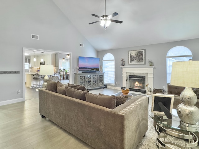 482 Planters Trace Dr, Charleston, SC 29412 - living room featuring high vaulted ceiling, light wood-type flooring, a ceiling fan, a high end fireplace, and baseboards