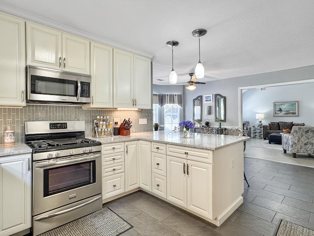 482 Planters Trace Dr, Charleston, SC 29412 - kitchen with appliances with stainless steel finishes, open floor plan, backsplash, and a ceiling fan