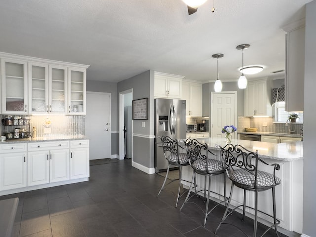 482 Planters Trace Dr, Charleston, SC 29412 - kitchen featuring stainless steel fridge with ice dispenser, tasteful backsplash, and white cabinetry