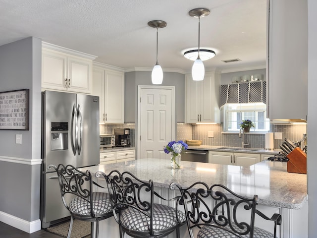482 Planters Trace Dr, Charleston, SC 29412 - kitchen with appliances with stainless steel finishes, a sink, a kitchen breakfast bar, light stone counters, and crown molding