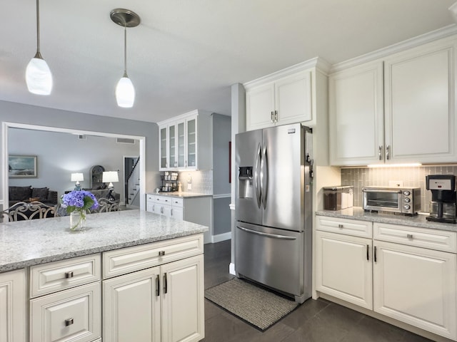 482 Planters Trace Dr, Charleston, SC 29412 - kitchen featuring stainless steel fridge, white cabinetry, tasteful backsplash, decorative light fixtures, and light stone countertops