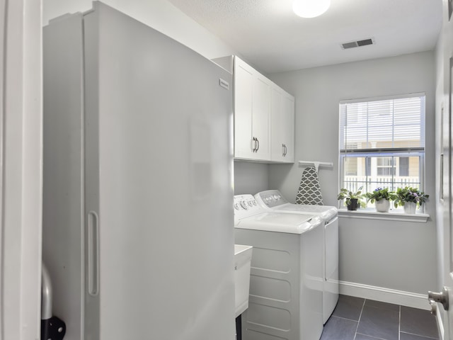 482 Planters Trace Dr, Charleston, SC 29412 - laundry area with washer and dryer, cabinet space, baseboards, and dark tile patterned flooring
