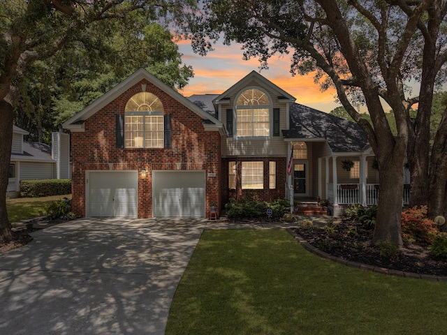 482 Planters Trace Dr, Charleston, SC 29412 - traditional home with a garage, concrete driveway, brick siding, a lawn, and a porch