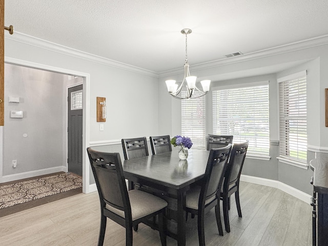 482 Planters Trace Dr, Charleston, SC 29412 - dining area featuring light wood-style flooring, a chandelier, ornamental molding, baseboards, and a textured ceiling