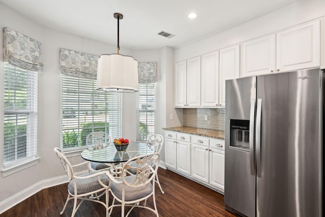 708 Lawton Harbor Dr, Charleston, SC 29412 - kitchen with stainless steel fridge with ice dispenser, white cabinetry, light stone counters, tasteful backsplash, and dark wood-style flooring