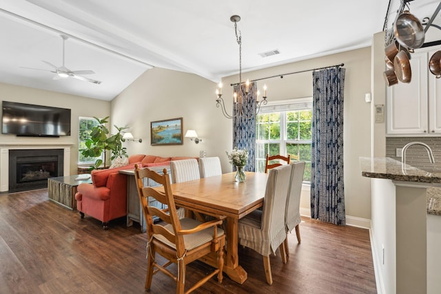 708 Lawton Harbor Dr, Charleston, SC 29412 - dining space featuring dark wood finished floors, a glass covered fireplace, a chandelier, and a ceiling fan