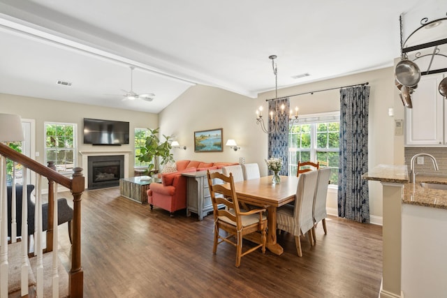 708 Lawton Harbor Dr, Charleston, SC 29412 - dining space with a fireplace, dark wood-style floors, a chandelier, and a ceiling fan