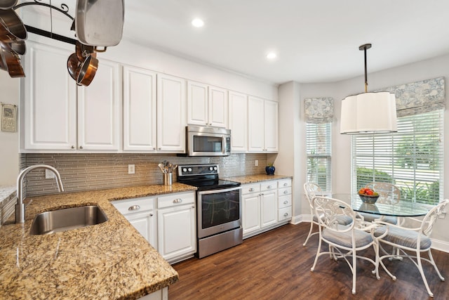 708 Lawton Harbor Dr, Charleston, SC 29412 - kitchen with appliances with stainless steel finishes, white cabinets, decorative backsplash, dark wood finished floors, and light stone counters
