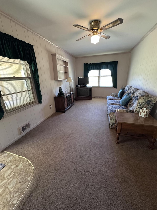 686 W Pine St, Varnville, SC 29944 - living area with ornamental molding, a ceiling fan, light carpet, and wood walls