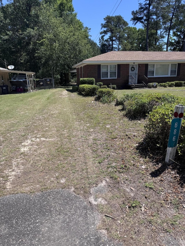 686 W Pine St, Varnville, SC 29944 - view of front of house with a front lawn and brick siding