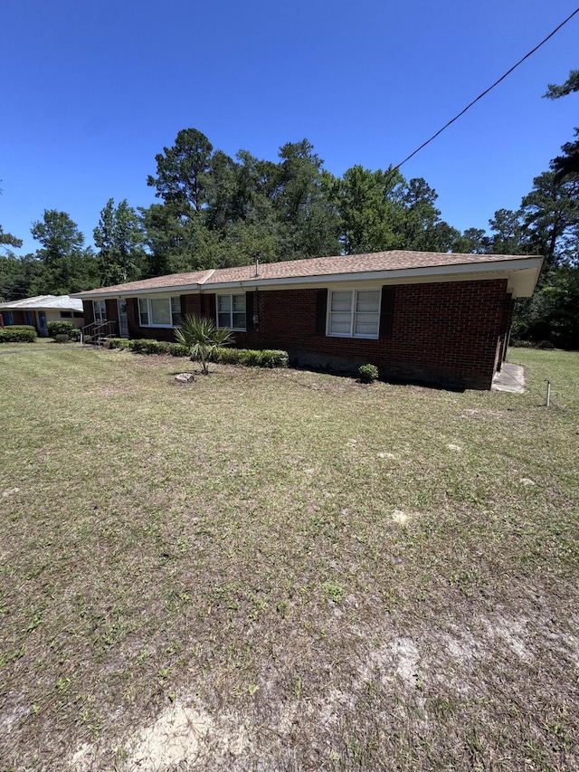 686 W Pine St, Varnville, SC 29944 - view of front facade with a front lawn and brick siding