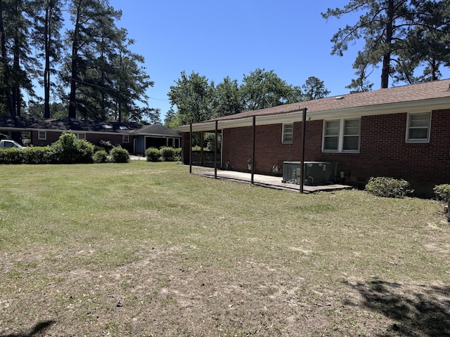 686 W Pine St, Varnville, SC 29944 - back of house featuring a patio, a yard, and brick siding