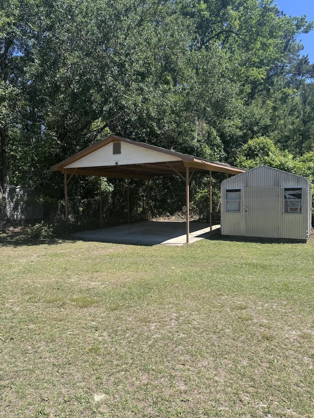 686 W Pine St, Varnville, SC 29944 - view of green lawn featuring an outbuilding and a detached carport